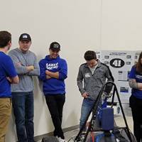 a group of people around a car